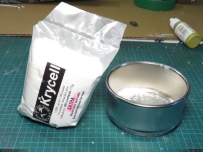 A bag of Krycell Snow and the stainless steel sieve