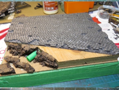 I removed some individual stones from the road to damage it. Then pieces of cork were glued on the "crater" part of the diorama.